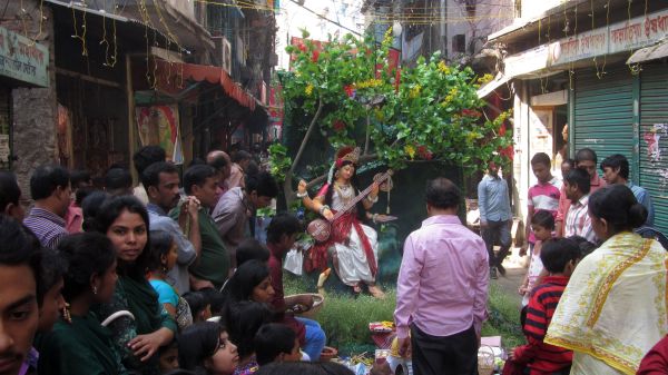 People celebrating Saraswati (सरस्वती), goddess of knowledge, music, arts and science, on the streets of Dhaka, Bangladesh